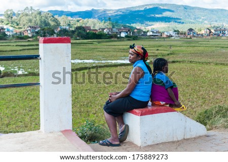 ANTANANARIVO, MADAGASCAR - JUNE 30, 2011: Unidentified Madagascar woman and her child sit and think. People in Madagascar suffer of poverty due to the slow development of the country