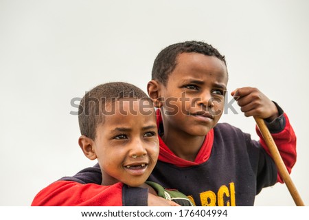 OMO, ETHIOPIA - SEPTEMBER 19, 2011: Unidentified Ethiopian cute kids friends hug each other. People in Ethiopia suffer of poverty due to the unstable situation