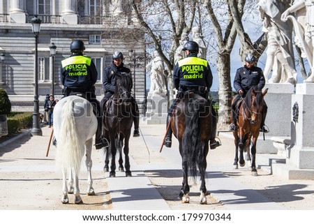 MADRID, SPAIN - MAR 4, 2014: Horse police near the Royal Palace, Madrid, Spain. Royal Palace is the official residence of the Spanish Royal Family