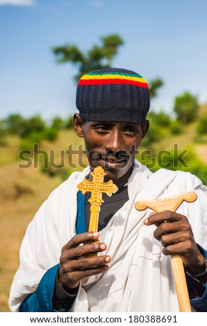 LALIBELA, ETHIOPIA - SEPTEMBER 28, 2011: Unidentified Ethiopian man with a cross in his hands. People in Ethiopia suffer of poverty due to the unstable situation