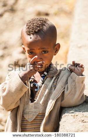 LALIBELA, ETHIOPIA - SEPTEMBER 28, 2011: Unidentified Ethiopian little boy in old clothes in the street. People in Ethiopia suffer of poverty due to the unstable situation