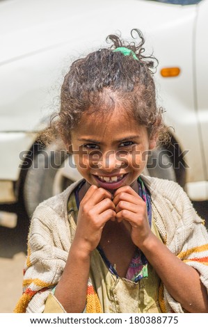 LALIBELA, ETHIOPIA - SEPTEMBER 28, 2011: Unidentified Ethiopian smiling funny girl watches the camera. People in Ethiopia suffer of poverty due to the unstable situation
