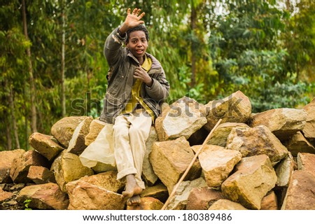 AKSUM, ETHIOPIA - SEPTEMBER 24, 2011: Unidentified Ethiopian boy waves his hand. People in Ethiopia suffer of poverty due to the unstable situation
