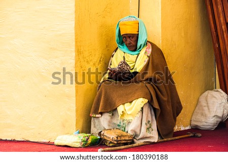 AKSUM, ETHIOPIA - SEPTEMBER 24, 2011: Unidentified Ethiopian woman sells hand made bags. People in Ethiopia suffer of poverty due to the unstable situation