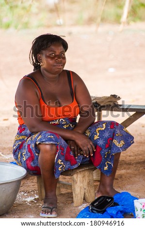PORTO-NOVO, BENIN - MAR 8, 2012: Unidentified Beninese fat woman works at the market. People of Benin suffer of poverty due to the difficult economic situation.