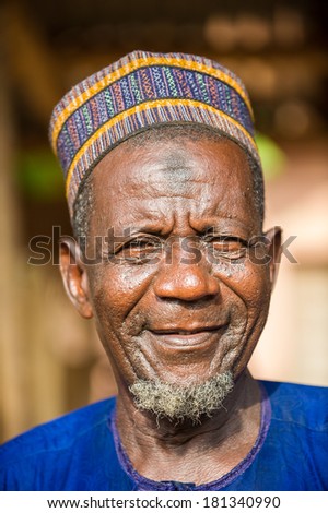 PORTO-NOVO, BENIN - MAR 8, 2012: Portrait of Unidentified Beninese old man smiling in a typical hat. People of Benin suffer of poverty due to the difficult economic situation.