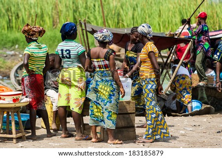 PORTO-NOVO, BENIN - MAR 9, 2012: Unidentified Beninese people at the local market. People of Benin suffer of poverty due to the difficult economic situation