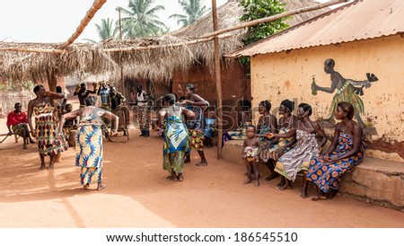 KARA, TOGO - MAR 11, 2012:  Unidentified Togolese women dance the religious voodoo dance and other watch it. Voodoo is the West African religion
