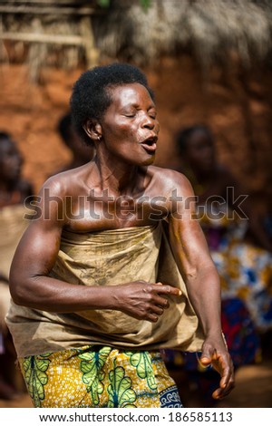 KARA, TOGO - MAR 11, 2012:  Unidentified Togolese woman in traditional dress dances the religious voodoo dance. Voodoo is the West African religion