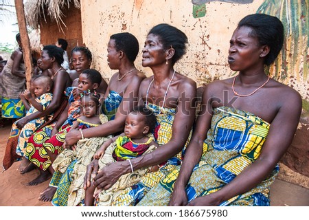 KARA, TOGO - MAR 11, 2012:  Unidentified Togolese women in a traditional dress watch the religious voodoo dance. Voodoo is the West African religion