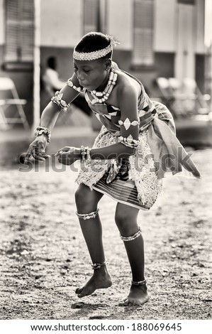 ACCRA, GHANA - MAR 3, 2012: Unidentified Ghanaian woman in traditional dress dances in the street. Music is one of the main kinds of entertainment in Africa