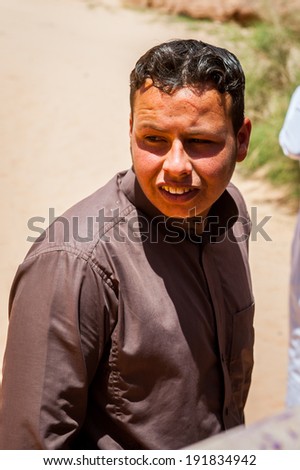 WADI RUM, JORDAN - APR 30, 2014: Unidentified tourist walks in the Wadi Rum valley. Wadi Rum valley is the UNESCO World Heritage site