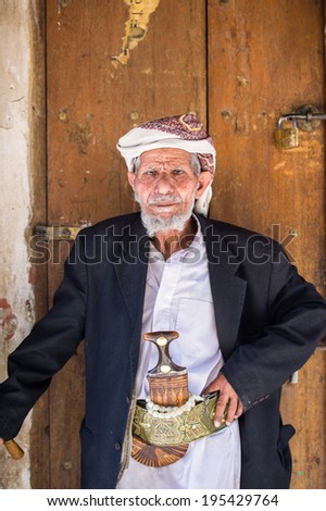 SANA\'A, YEMEN - JAN 11, 2014: Unidentified Yemeni man near the door  in Sana\'a. People of Yemen suffer of poverty due to the unstable political and poor economical situation