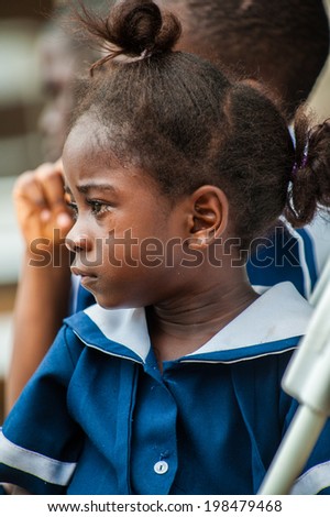 ACCRA, GHANA - MARCH 4, 2012: Unidentified Ghanaian girl cries in a school uniform in Ghana. School uniform is a part of the humanitarian help to Africa from the others countries
