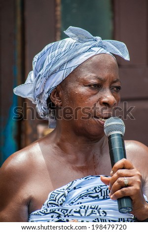ACCRA, GHANA - MARCH 4, 2012: Unidentified Ghanaian woman sings a song at the local street music show in Ghana. Music is the main kind of entertainment in Africa