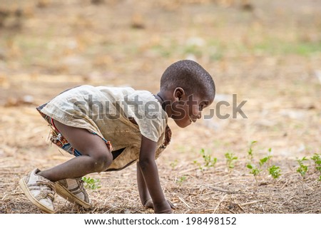 ACCRA, GHANA - MARCH 6, 2012: Unidentified Ghanaian boy is going to run in the street in Ghana. Children of Ghana suffer of poverty due to the unstable economic situation