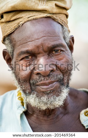 ACCRA, GHANA - MARCH 6, 2012: Unidentified Ghanaian old man with a hat in the street in Ghana. People of Ghana suffer of poverty due to the unstable economic situation