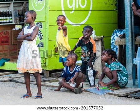 ACCRA, GHANA - MARCH 3, 2012: Unidentified Ghanaian children in the street in Ghana. People of Ghana suffer of poverty due to the unstable economic situation