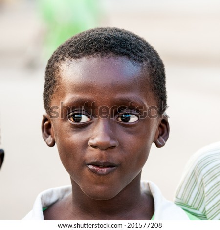 ACCRA, GHANA - MARCH 3, 2012: Unidentified Ghanaian boy in the street in Ghana. People of Ghana suffer of poverty due to the unstable economic situation