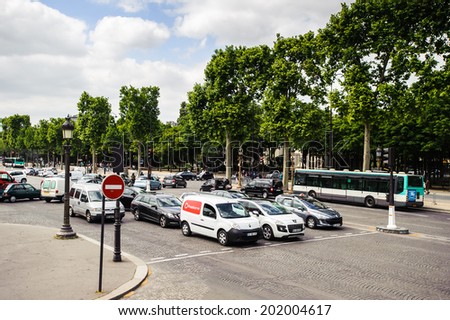 PARIS, FRANCE - JUN 17, 2014: Traffic in Paris, France. Paris is one of the most popular touristic destinations in the world