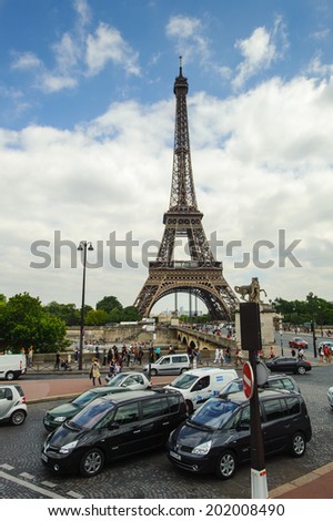 PARIS, FRANCE - JUN 17, 2014: Traffic of Paris and the Eiffel Tower in Paris, France. The Eiffel tower was created by Gustave Eiffel and the construction was completed in 1889