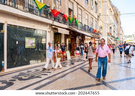 LISBON, PORTUGAL - JUN 20, 2014:  Unidentified people walk on the touristic street in Lisbon, Portugal. Lisbon is the westernmost large city Europe and the seventh-most-visited city in Southern Europe