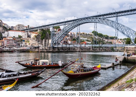 PORTO, PORTUGAL - JUN 21, 2014: Boats and the Bridge Dom Luis I, Porto, Portugal. View from the River Douro, one of the major rivers of the Iberian Peninsula (2157 m)