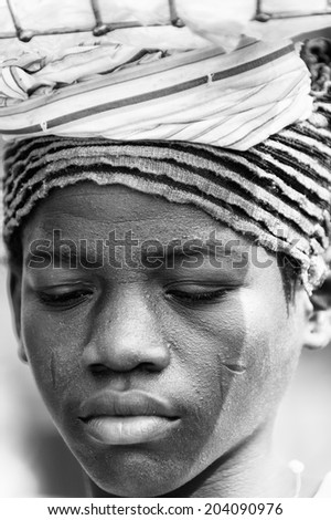 ACCARA, GHANA - MAR 4, 2012: Unidentified Ghanaian woman portrait in black and white. People of Ghana suffer of poverty due to the unstable economical situation