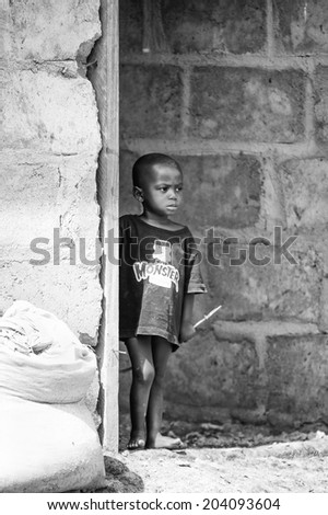 ACCARA, GHANA - MAR 3, 2012: Unidentified Ghanaian little boy portrait in black and white. People of Ghana suffer of poverty due to the unstable economical situation