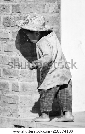 ANTANANARIVO, MADAGASCAR - JULY 1, 2011: Unidentified Madagascar boy runs in the street. People in Madagascar suffer of poverty due to slow development of the country