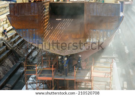 CAPE TOWN, SOUTH AFRICA - FEB 22, 2013: Unidentified workers work on the ship in Cape Town, South Africa. Cape town is the most popular international touristic destination in Africa