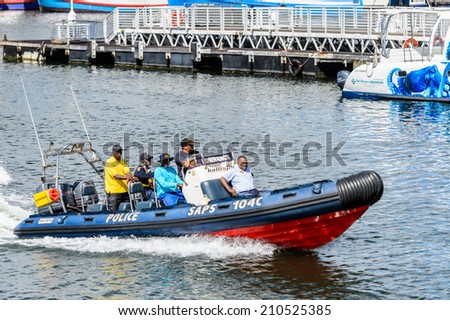 CAPE TOWN, SOUTH AFRICA - FEB 22, 2013: Unidentified people on a boat in the harbor in Cape Town, South Africa. Cape town is the most popular international touristic destination in Africa