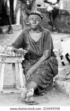 PORTO-NOVO, BENIN - MAR 10, 2012: Unidentified Beninese local woman sells bananas. People of Benin suffer of poverty due to the difficult economic situation