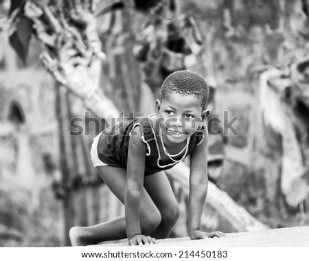 PORTO-NOVO, BENIN - MAR 9, 2012: Unidentified Beninese little girl plays outdoor. Children of Benin suffer of poverty due to the difficult economic situation