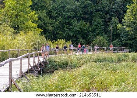 PLITVICE LAKE NATIONAL PARK, CROATIA - AUG 19, 2014: Unidentified people walk in the Plitvice Lakes National Park, which is a UNESCO World Heritage site