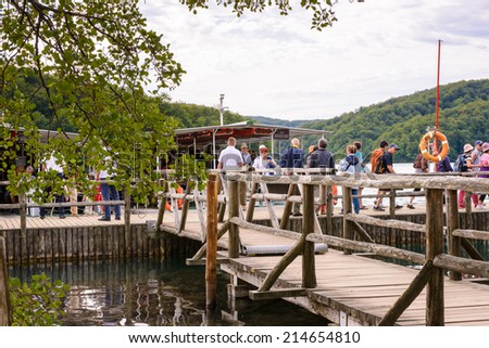 PLITVICE LAKE NATIONAL PARK, CROATIA - AUG 19, 2014: Unidentified people   getting on board in the Plitvice Lakes National Park, which is a UNESCO World Heritage site