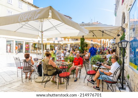 SPLIT, CROATIA - AUG 22, 2014: Unidentified tourists in a restaurant in Split, Croatia. Split is the largest city of the region of Dalmatia and a popular touristic destination