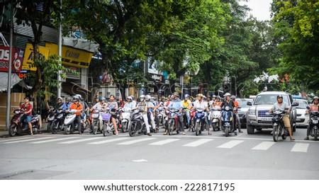 HA NOI, VIETNAM - SEP 23, 2014: Many people on the motorbikes on the road of Hanoi. Motorbike is the most populat way of transportation in Vietnam