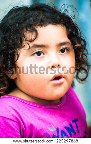 GUATEMALA CITY, GUATEMALA - JANUARY 3, 2012: Portrait of an unidentified beautiful fat  girl playing outdoors in Guatemala. 59.4% of Guatemala people belong to the Mestizo ethnic group