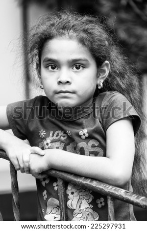 GUATEMALA CITY, GUATEMALA - JANUARY 1, 2012: Portrait of unidentified little little girl in a shirt in Guatemala. 59.4% of Guatemala people belong to the Mestizo ethnic group