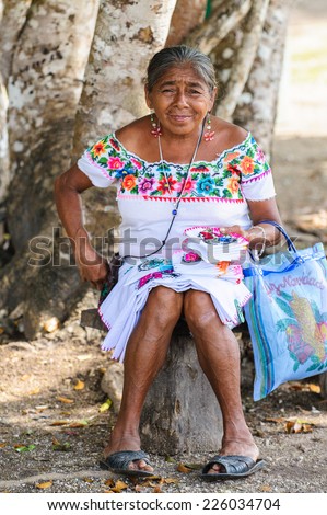MEXICO CITY, MEXICO - DEC 29, 2011: Unidentified Mexican woman in traditional clothes sells napkins. 60% of Mexican people belong to the Mestizo ethnic group