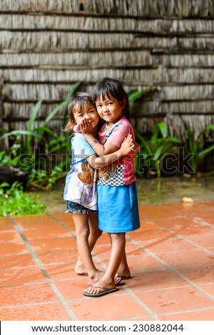 SIEM RIEP, CAMBODIA - SEP 28, 2014: Unidentified Khmer little girls hug each other in Siem Reap. 90% of Cambodian people belong to Khmer etnic group