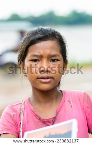SIEM RIEP, CAMBODIA - SEP 28, 2014: Unidentified Khmer girl in pink portrait in Siem Reap. 90% of Cambodian people belong to Khmer etnic group