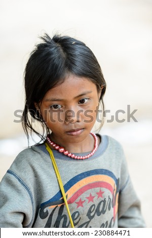 ANGKOR THOM, CAMBODIA - SEP 27, 2014: Unidentified Khmer girl at the Angkor Thom. 90% of Cambodian people belong to Khmer etnic group