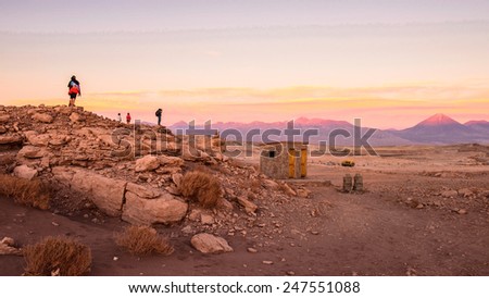 ATACAMA DESERT, CHILE - NOV 3, 2014: Unidentified tourists make pictures in the Atacama desert, Chile. Atacama Desert proper occupies 105,000 square kilometres