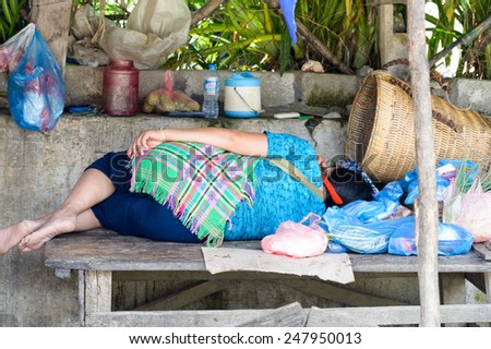 LAO CHAI VILLAGE, VIETNAM - SEP 22, 2014: Unidentified Hmong woman sleeps in Lao Chai. Hmong is on of the minority eethnic group in Vietnam