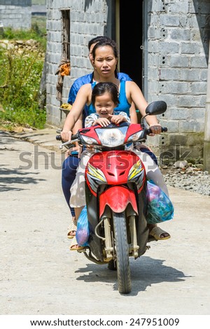 LAO CHAI VILLAGE, VIETNAM - SEP 22, 2014: Unidentified Hmong woman rides a motorbike in Lao Chai. Hmong is on of the minority eethnic group in Vietnam