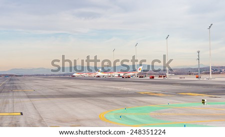 MADRID, SPAIN - JAN 26, 2015: Aircraft of Iberia in the Adolfo Suarez Madrid Barajas Airport. Barajas  is the main international airport serving Madrid in Spain.