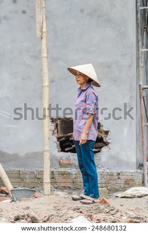 HANOI, VIETNAM - SEP 23, 2014: Unidentified Vietnamese man works in construction. 92% of Vietnamese people belong to the Viet ethnic group