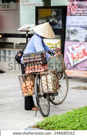 HANOI, VIETNAM - SEP 23, 2014: Unidentified Vietnamese manwith a bike charged with different products. 92% of Vietnamese people belong to the Viet ethnic group